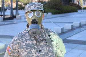 A soldier wearing a terrifying gas mask, representing atomic veterans who were exposed to radiation.
