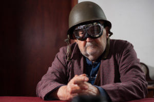 Image of an atomic veteran man wearing aviator glasses and a helmet.
