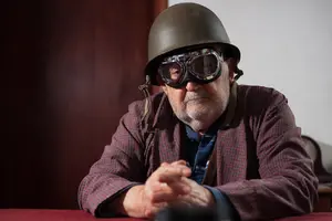 Image of an atomic veteran man wearing aviator glasses and a helmet.
