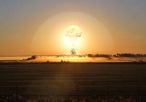 The explosion of the atomic bomb during atmospheric nuclear testing.